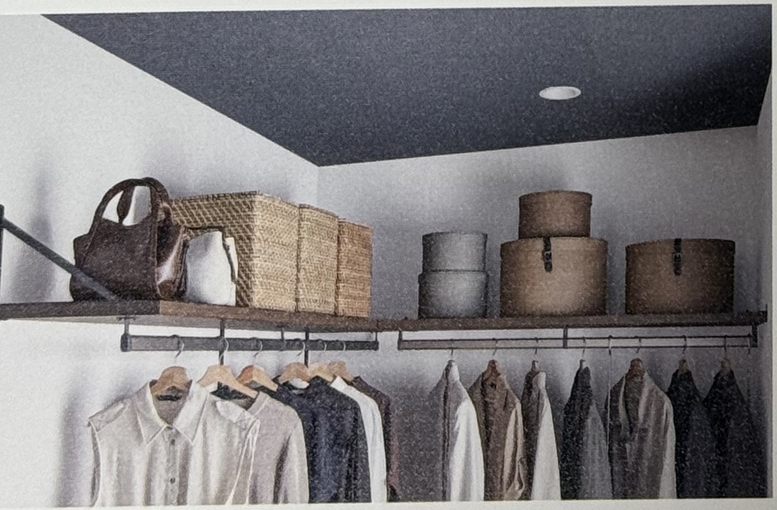 Next Walk-in Closetの天棚。天井近くの棚にかごや収納ボックスが置かれ、その下のハンガーパイプに服が掛かっている